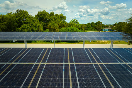 Aerial view of solar panels installed as shade roof over parking lot for parked cars for effective generation of clean electricity. Photovoltaic technology integrated in urban infrastructureの写真素材