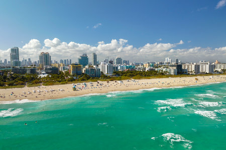Aerial view of South Beach sandy surface with tourists relaxing on hot Florida sun. Miami Beach city with high luxury hotels and condos. Tourism infrastructure in southern USAの写真素材