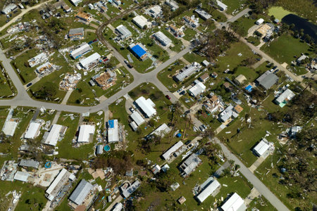 Consequences of natural disaster in southern Florida after hurricane season. Severely damaged houses in mobile home residential areaの写真素材