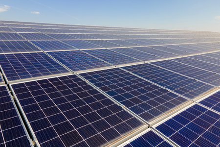 Photovoltaic panels on solar rooftops of commercial building for producing clean ecological electrical energy. Renewable electricity with zero emission conceptの写真素材
