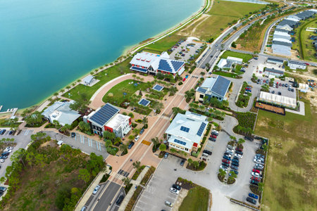 Solar photovoltaic panels installed on top of Florida office buildings for producing clean ecological electric energy. Renewable electricity with zero emission conceptの写真素材