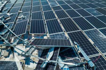 Top view of destroyed by hurricane Ian photovoltaic solar panels mounted on industrial building roof...