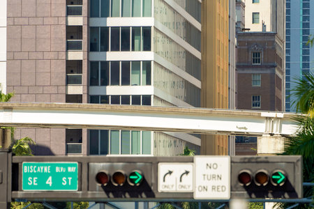 Traffic lights regulating driving cars on city street in Miami, Florida