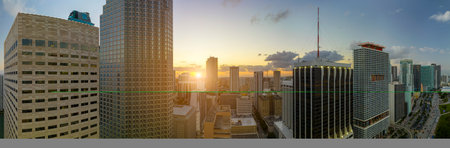 View from above of concrete and glass skyscraper buildings in downtown district of Miami Brickell in Florida, USA at sunset. American megapolis with business financial district at nightfallの写真素材