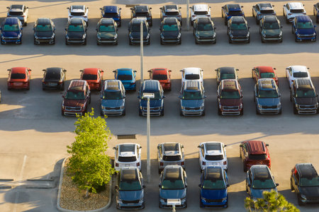 View from above of dealers outdoor parking lot with many brand new cars in stock for sale. Concept of development of american automotive industryの写真素材