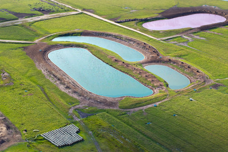Water ponds for farm cattle. Drink source for cows grazing in pasture fields. Green farm grassland in Floridaの写真素材