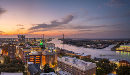Waterfront River Street in Savannah, Georgia. Historic American architecture of old historical city. USA Southern cityscape at sunsetの写真素材