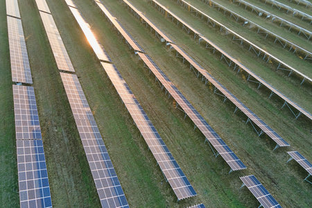 Aerial view of large sustainable electrical power plant with rows of solar photovoltaic panels for producing clean ecological electric energy. Renewable electricity with zero emission conceptの写真素材
