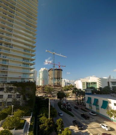 Aerial view of new developing residense in american urban area. Tower cranes at industrial construction site in Miami, Florida. Concept of housing growth in the USAの写真素材