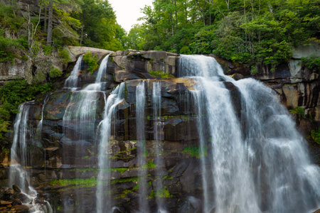 Amazing summer landscape with forest river waters falling down in big waterfall with clear water between rocky boulders in Nantahala National Forest. Whitewater Falls, North Carolina, USAの写真素材