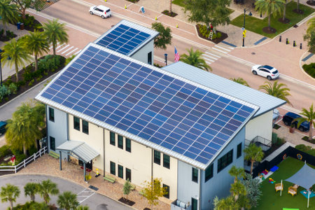 Autonomous building in Florida with photovoltaic rooftop covered with solar panels for producing of clean ecological electrical energy in town centerの写真素材
