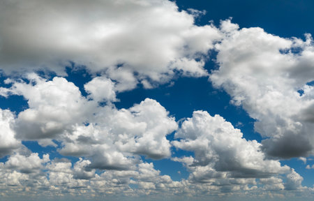 Blue sky with white summer rain clouds. Colorful summer landscapeの写真素材