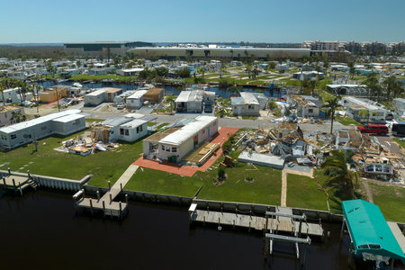 Consequences of natural disaster in Florida, USA. Aerial view of heavily damaged by hurricane Ian houses in mobile home residential areaの写真素材