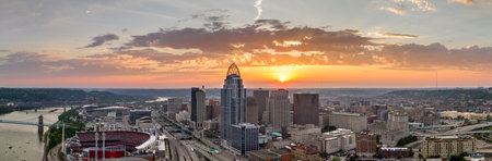 Downtown district of Cincinnati in Ohio, USA at sunset with brightly illuminated high skyscraper buildings. American travel destinationの写真素材