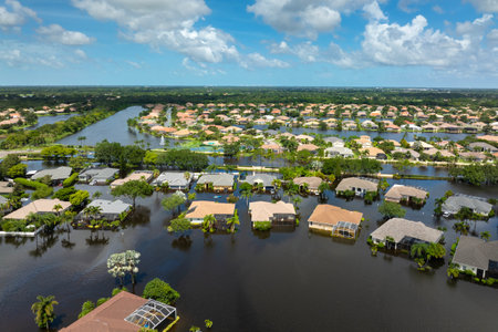 Flooded residential area with underwater houses from hurricane Debby rainfall water in Laurel Meadows community in Sarasota, Florida. Aftermath of natural disaster in southern USAの写真素材