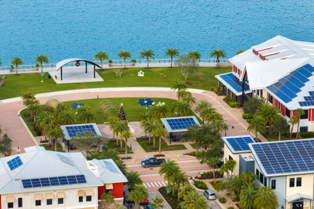 Florida office buildings with solar roof in small autonomous town. Blue photovoltaic panels for producing clean ecological electric energy. Investing in renewable electricity conceptの写真素材