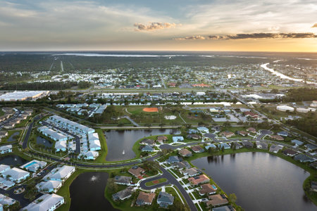 Gated community with expensive houses between green palm trees in southwest Florida. Premium housing development in the USAの写真素材