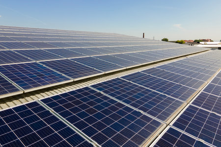 Office building with solar roof. Blue photovoltaic panels for producing clean ecological electric energy. Investing in renewable electricity conceptの写真素材