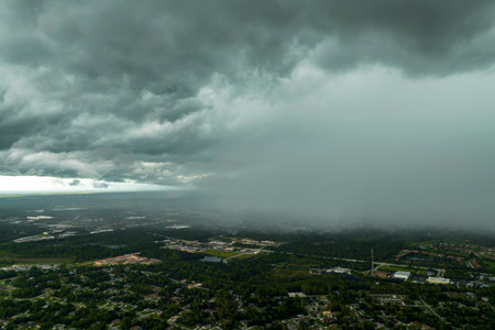 Rain shower water pouring down from stormy clouds during summer thunderstorm in rural Floridaの写真素材