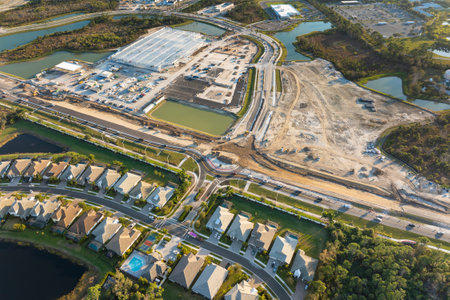 Roundabout intersection construction in North Port, Florida. Development of American road circle with moving traffic cars. Urban circular transportation crossroadsの写真素材