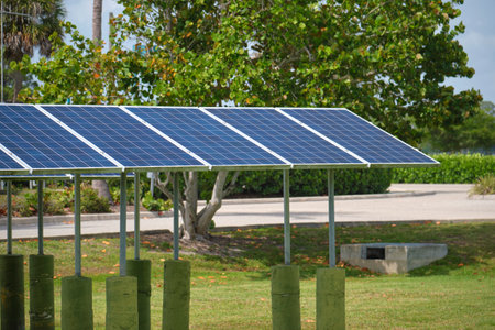 Solar panels installed on stand frame near parking lot for effective generation of clean electricity. Photovoltaic technology integrated in urban infrastructure for electric car chargingの写真素材