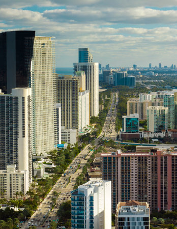 Sunny Isles Beach city with luxurious highrise hotels and condo buildings and busy ocean drive on Atlantic coast. American tourism infrastructure in southern Floridaの写真素材