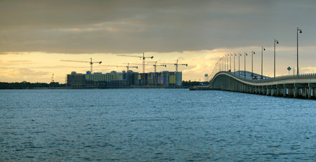 Tower cranes and frame structure of high residential apartment buildings at construction site. Developmentの写真素材