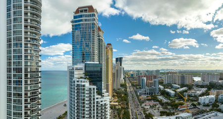 View from above of luxurious highrise hotels and condos on Atlantic ocean shore in Sunny Isles Beach city. American tourism infrastructure in southern Floridaの写真素材