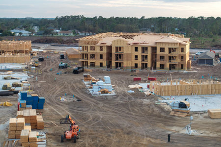 Wooden apartment buildings under construction in new developing suburban area. Development of...