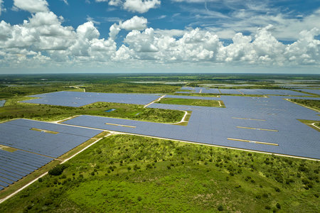 Aerial view of big sustainable electric power plant with many rows of solar photovoltaic panels for producing clean electrical energy. Renewable electricity with zero emission conceptの写真素材