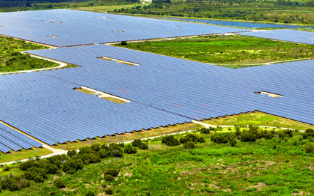 Aerial view of large sustainable electrical power plant with rows of solar photovoltaic panels for producing clean electric energy. Concept of renewable electricity with zero emissionの写真素材
