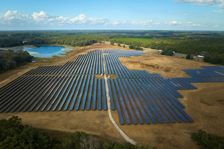 Aerial view of large sustainable electrical power plant with rows of solar photovoltaic panels for producing clean electric energy. Concept of renewable electricity with zero emissionの写真素材
