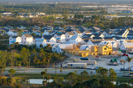 Aerial view of unfinished wooden frames of affordable houses under construction. Development of residential housing in American suburbs. Real estate market in the USAの写真素材