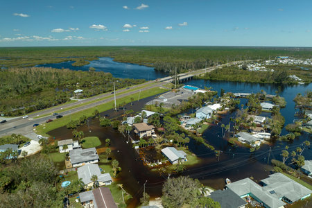 Aftermath of natural disaster. Surrounded by hurricane Ian rainfall flood waters homes in Florida residential areaの写真素材