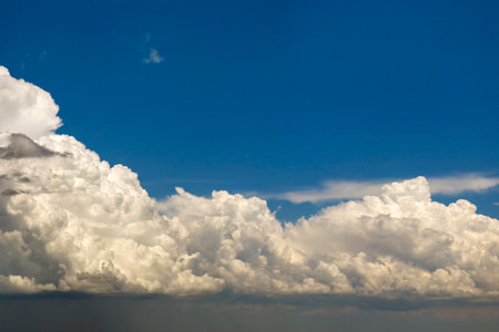 Blue sky with white summer rain clouds. Colorful summer landscapeの写真素材
