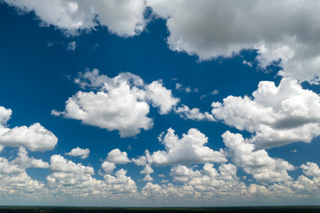 Blue sky with white summer rain clouds. Colorful summer landscapeの写真素材