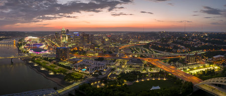 Cincinnati city, Ohio USA. View from above of brightly illuminated high skyscraper buildings in downtown district of American megapolis with business financial district at nightの写真素材