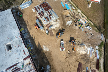 Construction site with building equipment on prepared ground in American suburbs. Aerial view of large development area of residential housing. Real estate market in the USAの写真素材