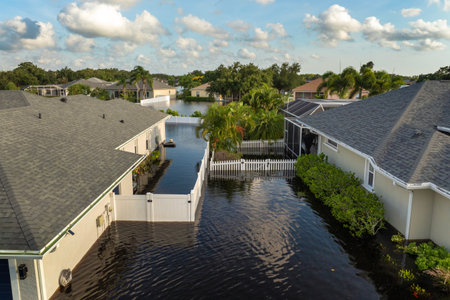 Flooded residential area with underwater houses from hurricane rainfall water in Florida suburban community. Aftermath of natural disaster in southern USAの写真素材