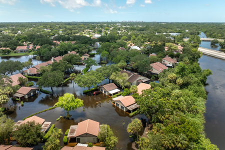 Flooding in Florida caused by tropical storm from hurricane Debby. Suburb houses in residential community surrounded by flood waters in Sarasota. Aftermath of natural disasterの写真素材