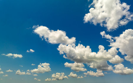 Blue sky with white summer rain clouds. Colorful summer landscapeの写真素材