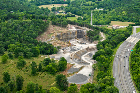 Industrial open-pit mining site with limestone quarry at mountain hillsideの写真素材