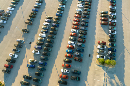Large parking lot of local dealer with many brand new cars parked for sale. Development of american automotive industry and distribution of manufactured vehicles conceptの写真素材