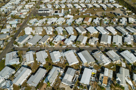 Property damage from strong hurricane winds. Mobile homes in Florida residential area with destroyed rooftops. Consequences of natural disasterの写真素材