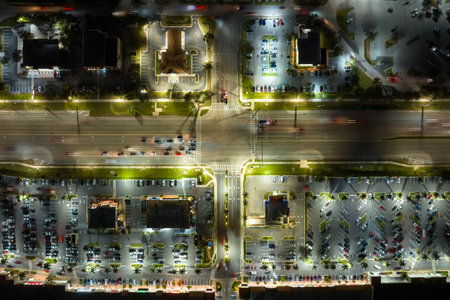 Strip mall plaza in North Port, Florida with illuminated traffic driving cars. USA transportation infrastructure conceptの写真素材