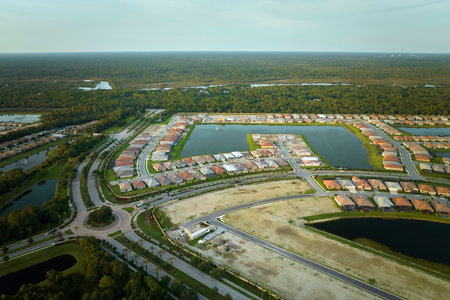 View from above of densely built residential houses under construction in closed living clubs in south Florida. American dream homes as example of real estate development in US suburbsの写真素材