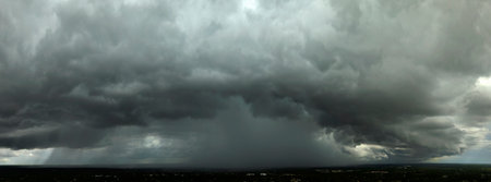 Rainstorm shower in Florida in humid summer season. Rain water pouring down from stormy clouds
