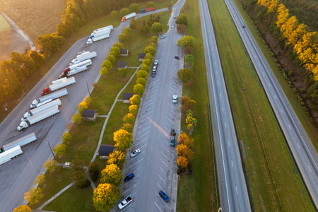 Aerial view of truck stop rest area near busy American interstate freeway. Recreational place during delivering cargo