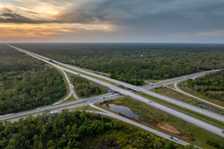 Highway intersection in Florida rural area at sunset. Elevated interchange lanes for express passing...