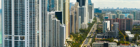Sunny Isles Beach city with luxurious highrise hotels and condo buildings and busy ocean drive on Atlantic coast. American tourism infrastructure in southern Floridaの写真素材